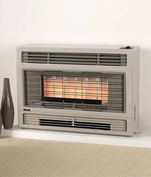 Freestanding gas space heater against a wall