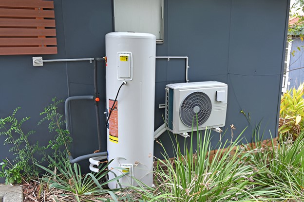 Gas storage hot water tank beside a house